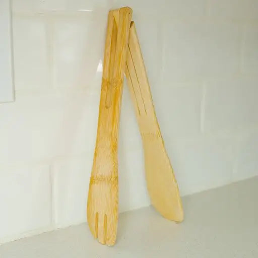 Pair of wooden tongs on a white background