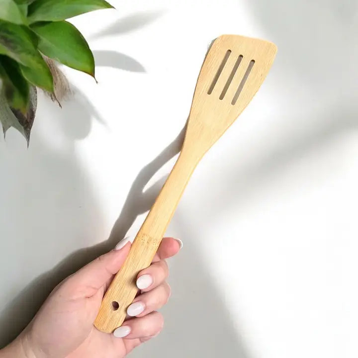 bamboo spatula held by a hand