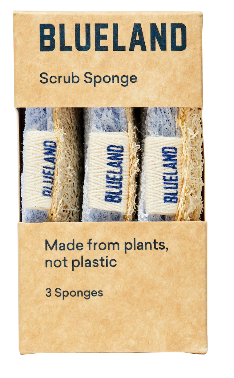 A box of Blueland Sponges 3-pack displays three plant-based kitchen sponges with BLUELAND on their twine bands. The brown paper packaging reads “Made from plants, not plastic” and “3 Sponges.”.