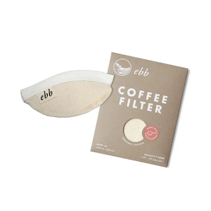 The Ebb Handheld Brewer by GDS Cloth Goods, a reusable coffee filter with "ebb" printed on its side, is pictured with its brown cardboard packaging labeled ebb and COFFEE FILTER on a white background.