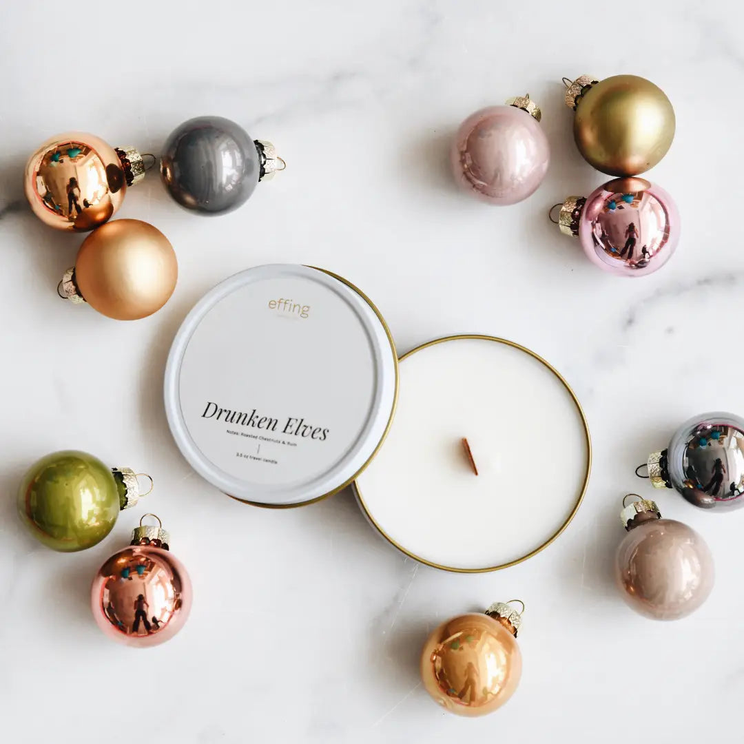 Decorative Christmas ornaments and candles on a marble surface