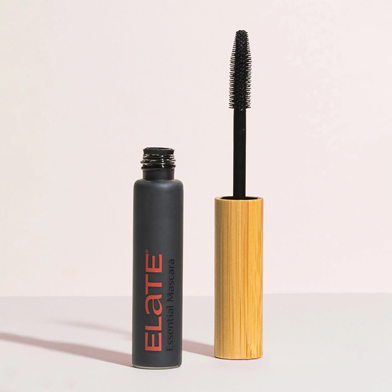 elate mascara container with bamboo wand next to it