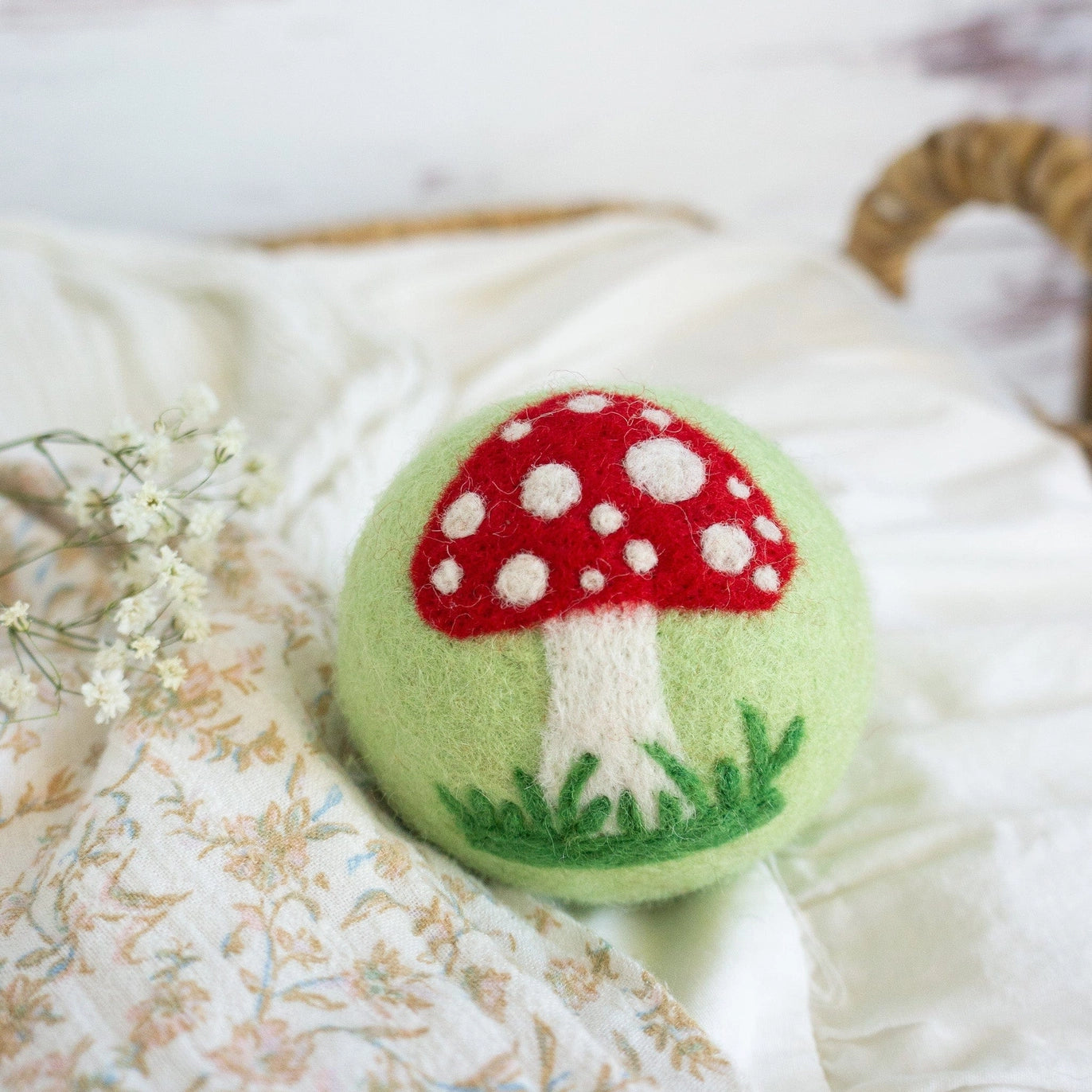 green wool dryer ball with mushroom