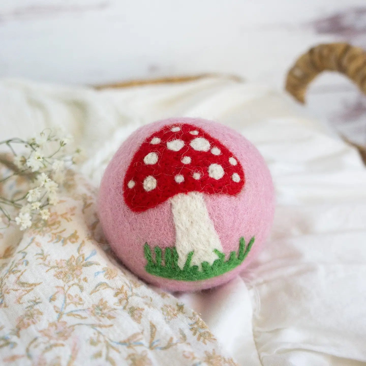 pink wool dryer ball with mushroom