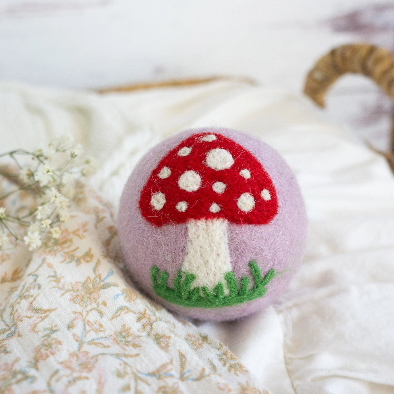 purple wool dryer ball with mushroom
