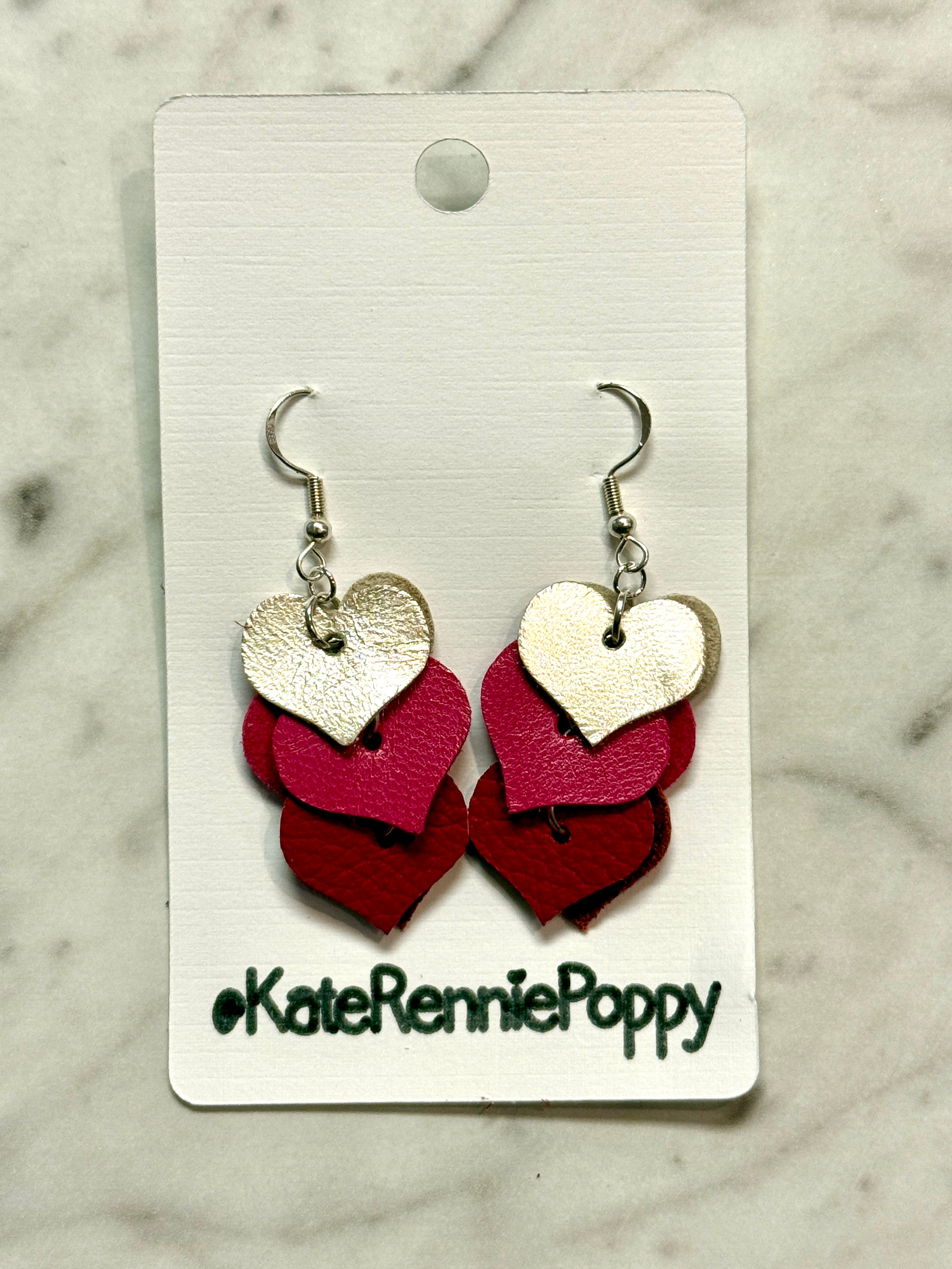 Heart-shaped earrings on a card with &