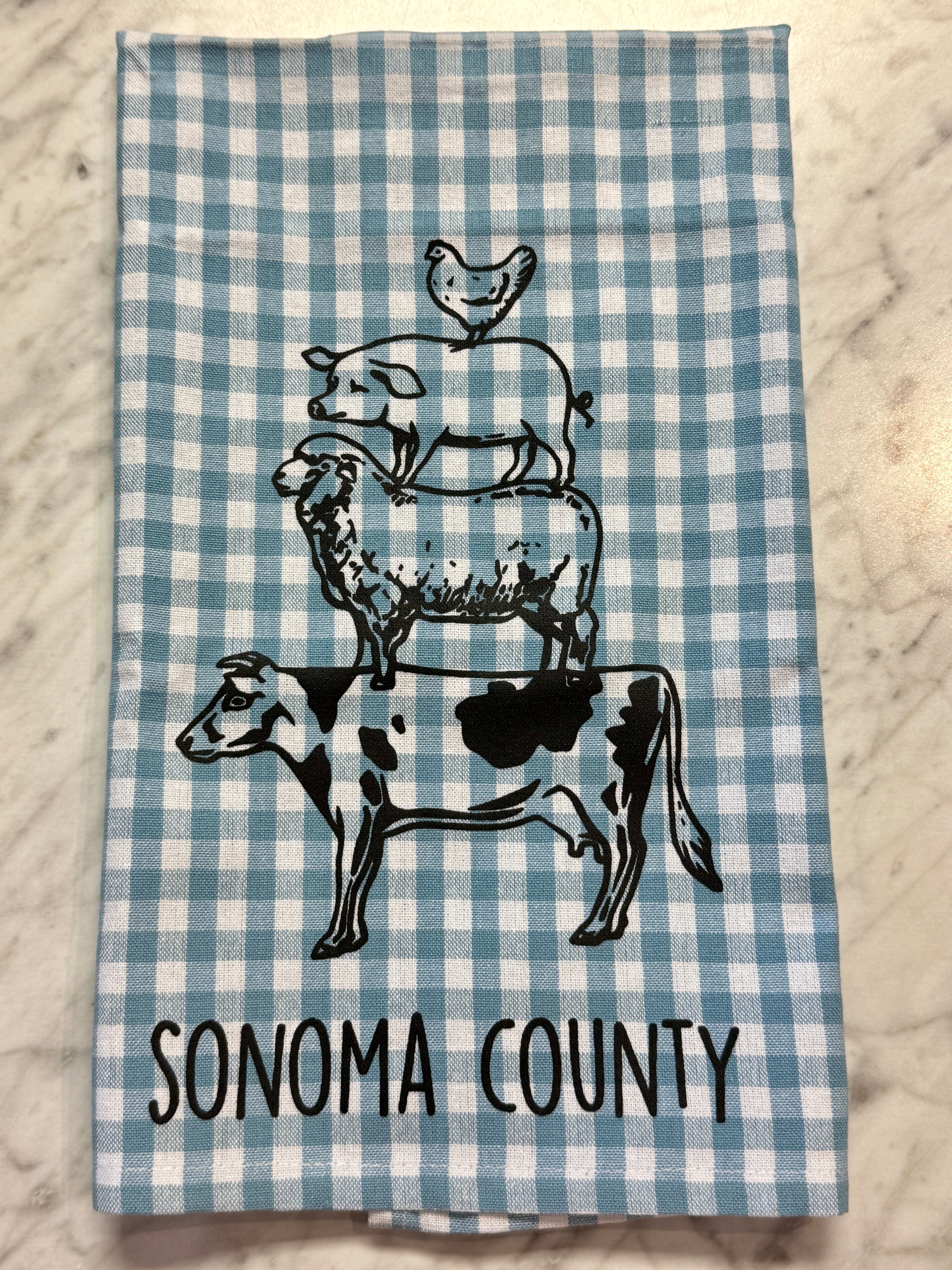 Checkered towel with farm animal illustrations and &