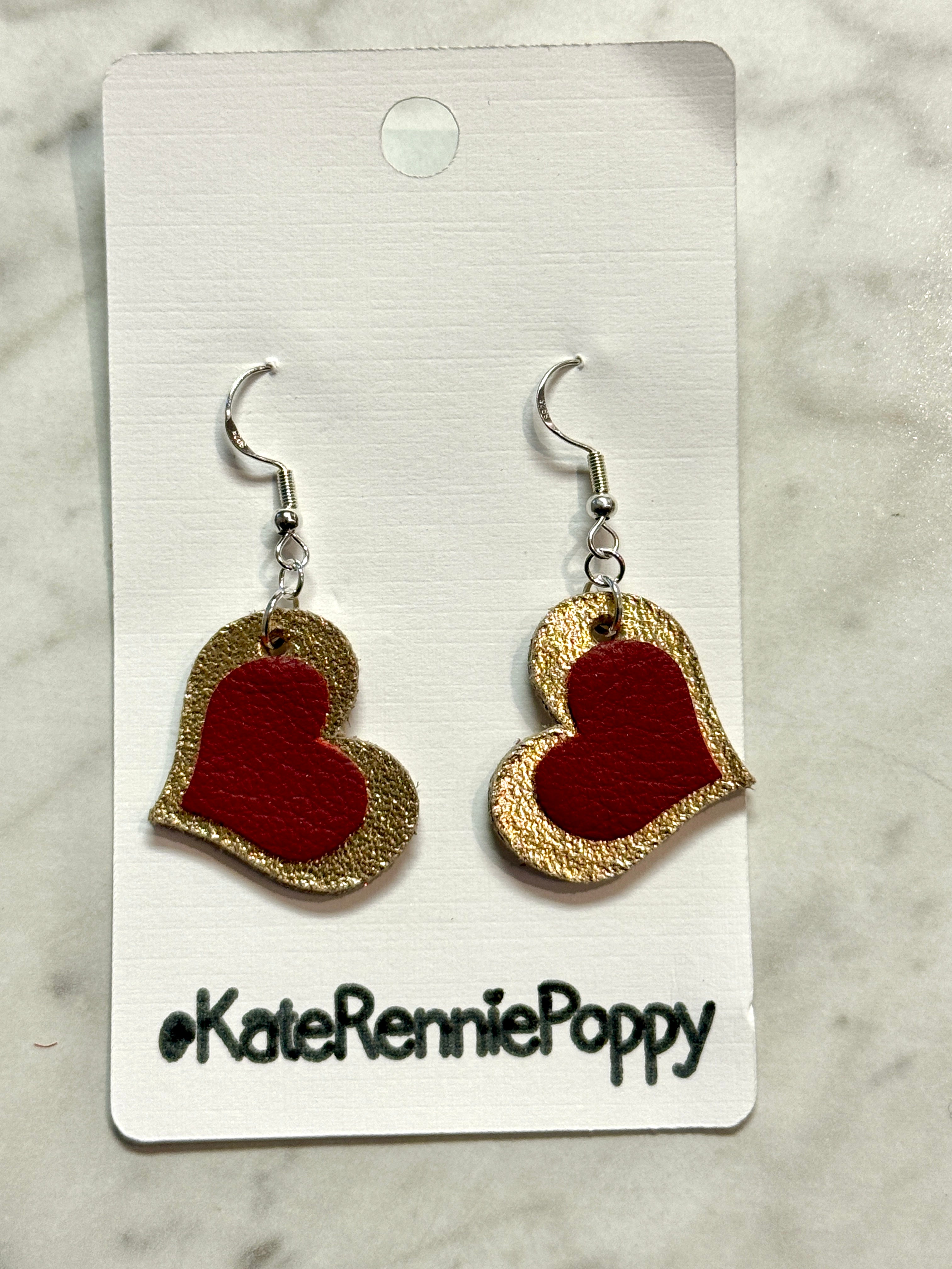 Heart-shaped earrings on a card with &