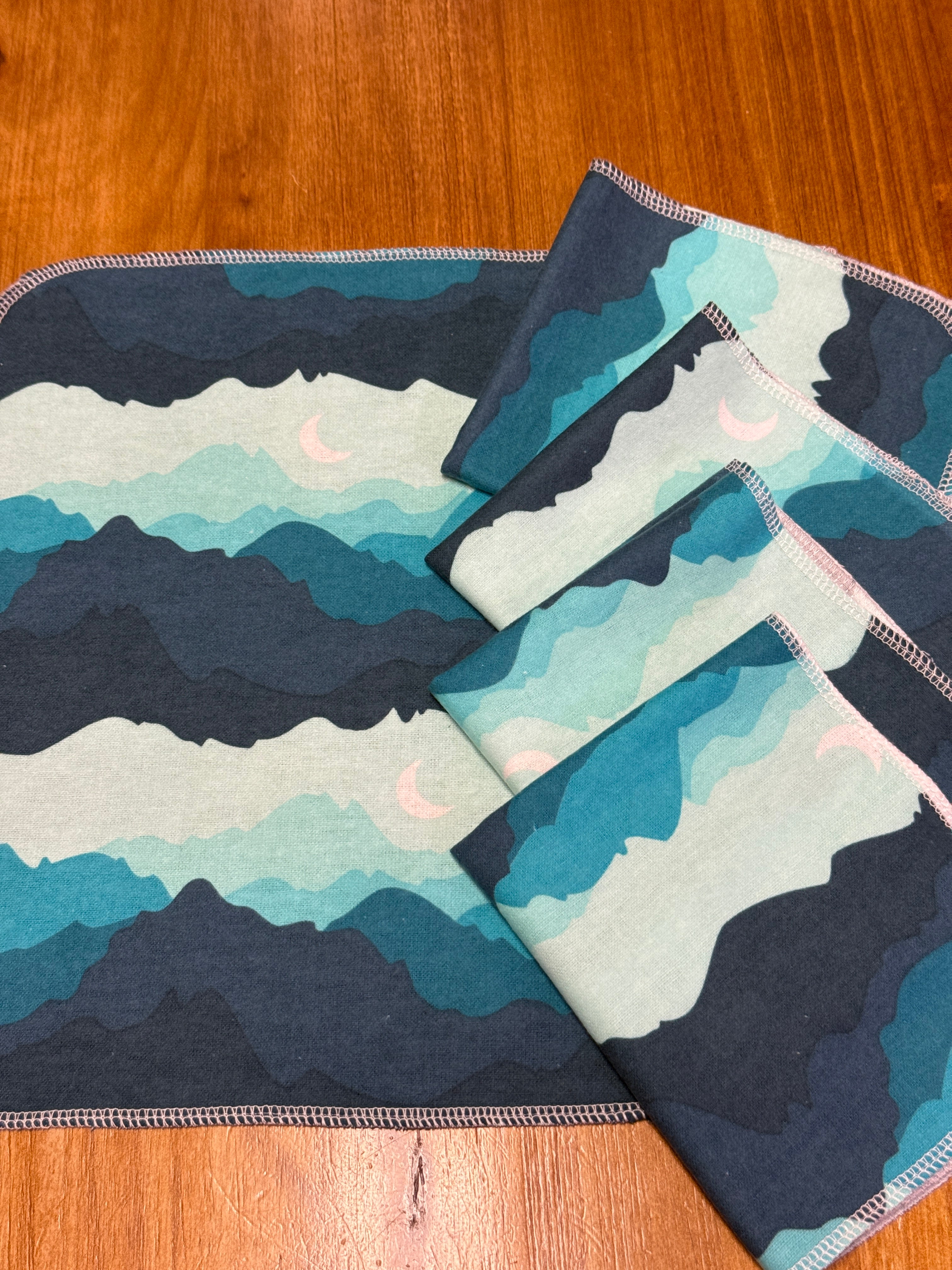 not paper towels lined up with blue green mountains