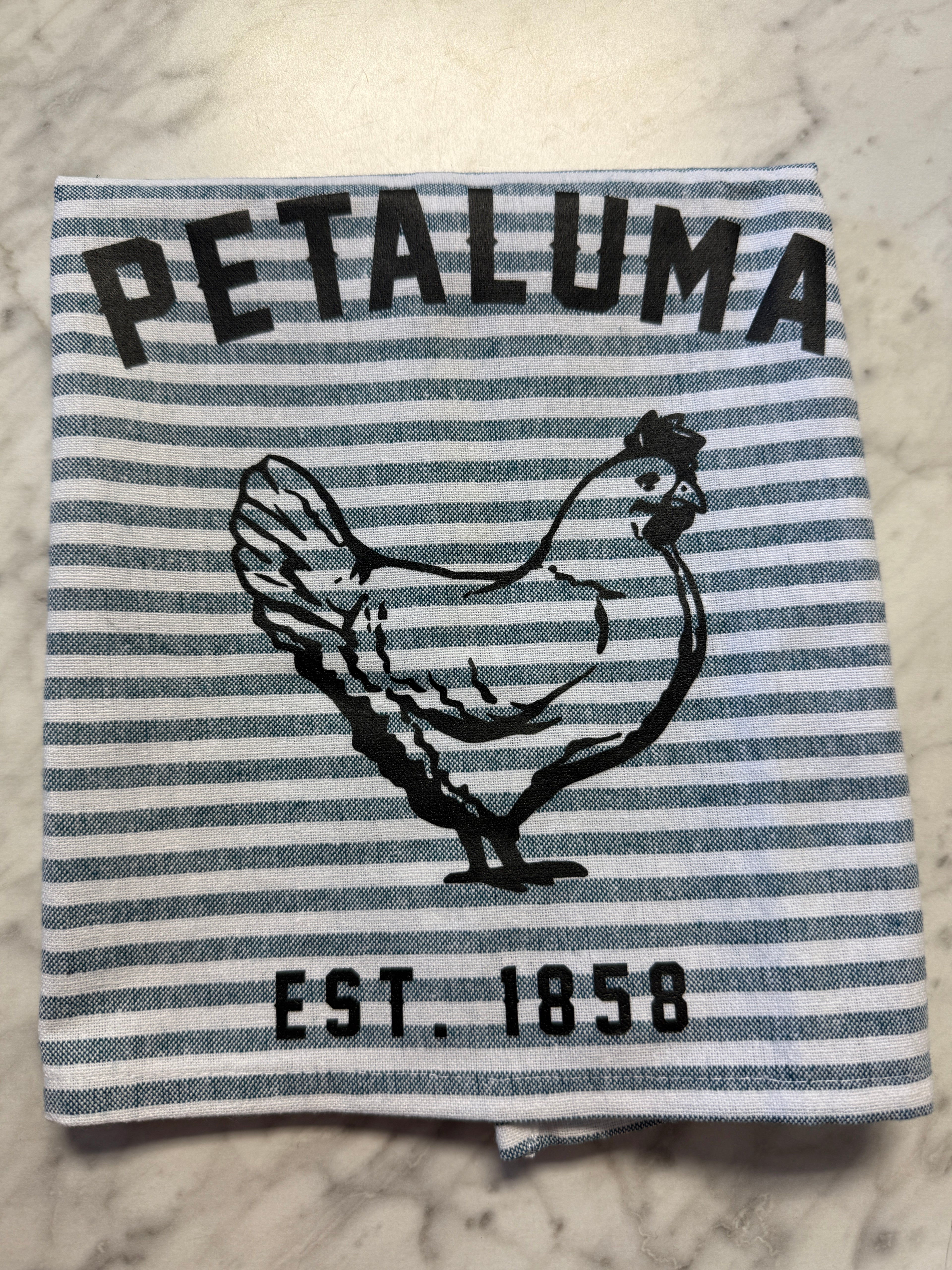 Striped towel with a logo and text on a textured surface