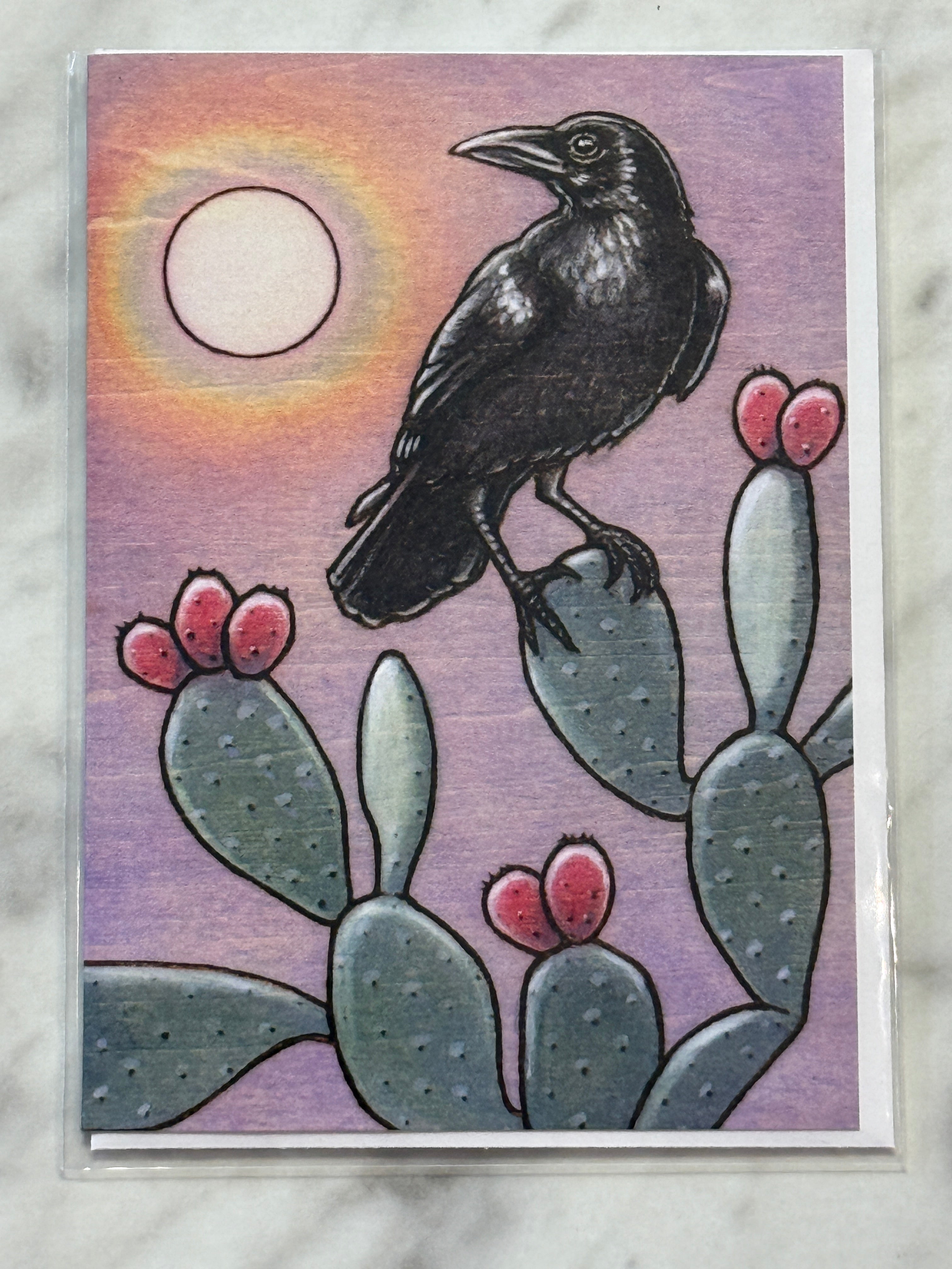 Card with a black bird and cactus illustration on a purple background