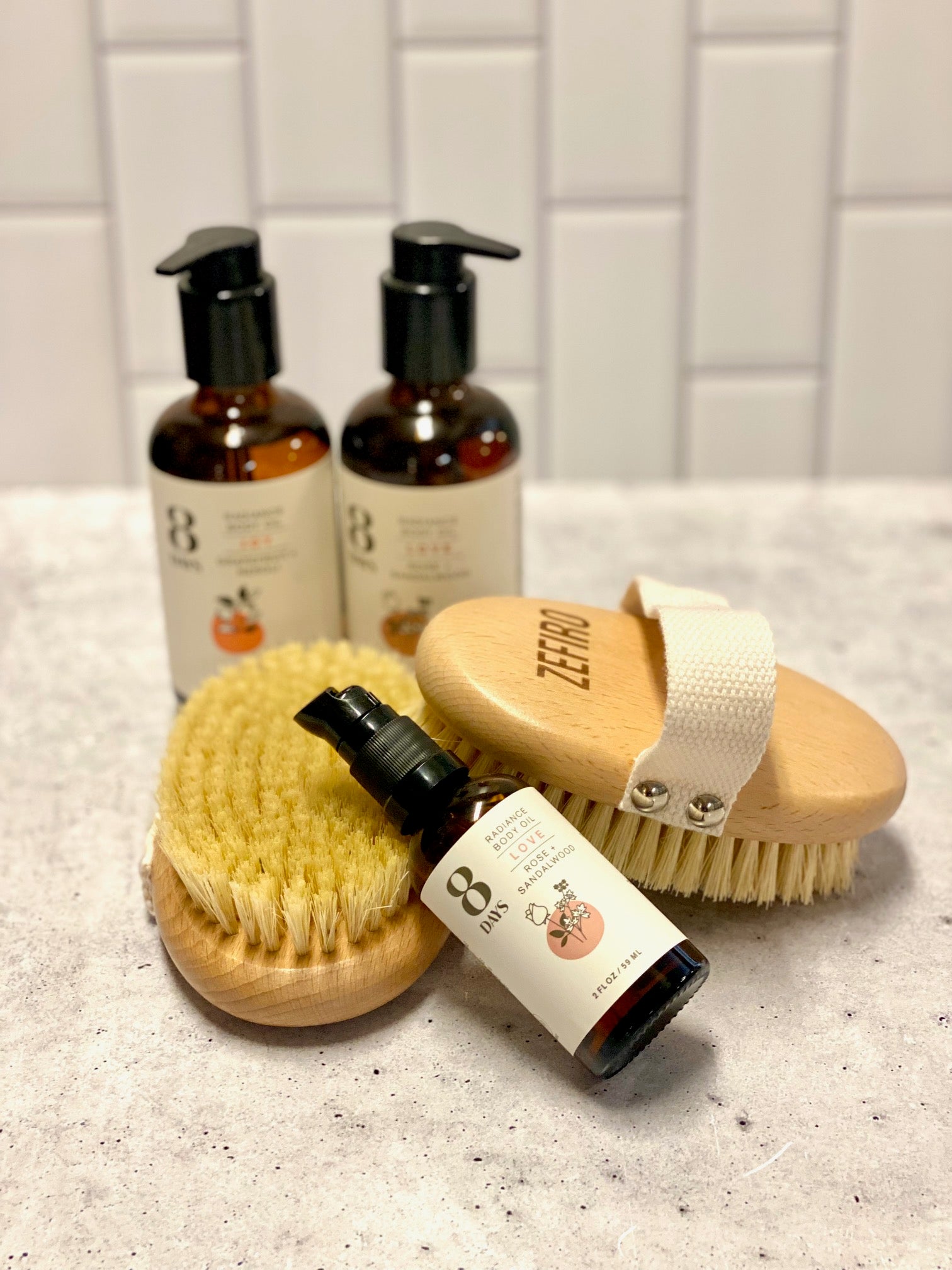 3 bottles of body oil and 2 dry brushes