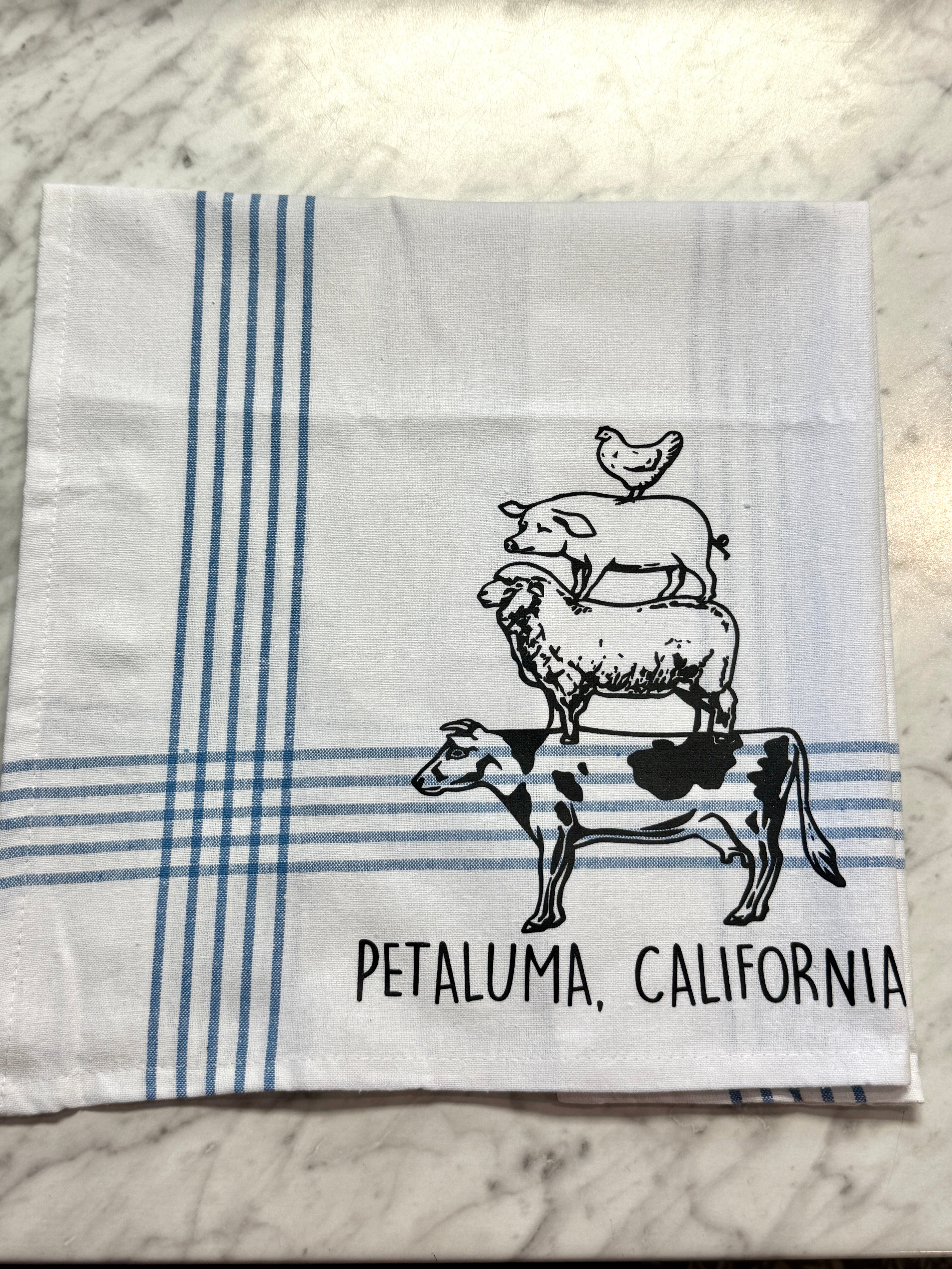 Folded towel with farm animal illustrations and &