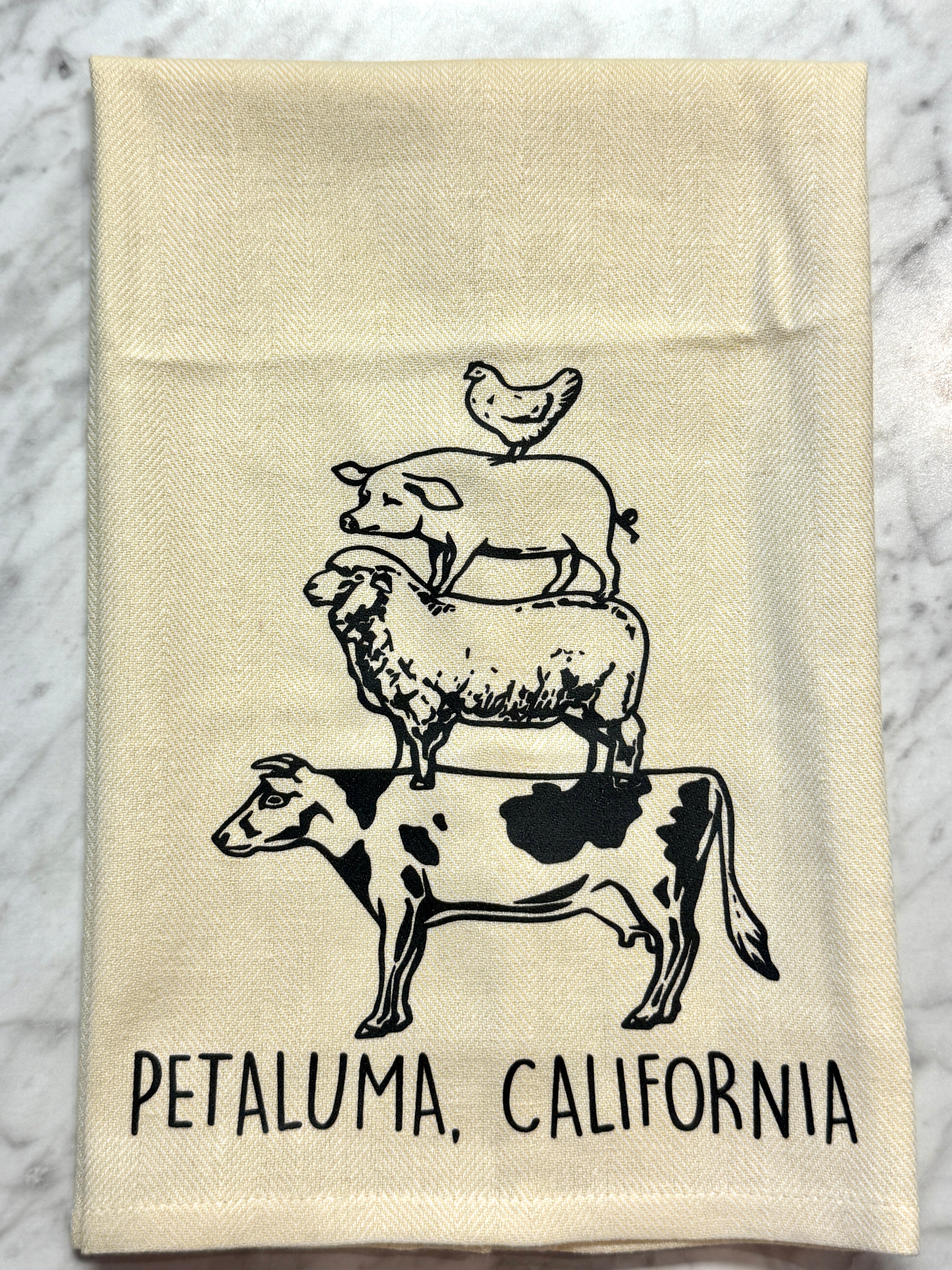 Beige towel with black animal illustrations and &