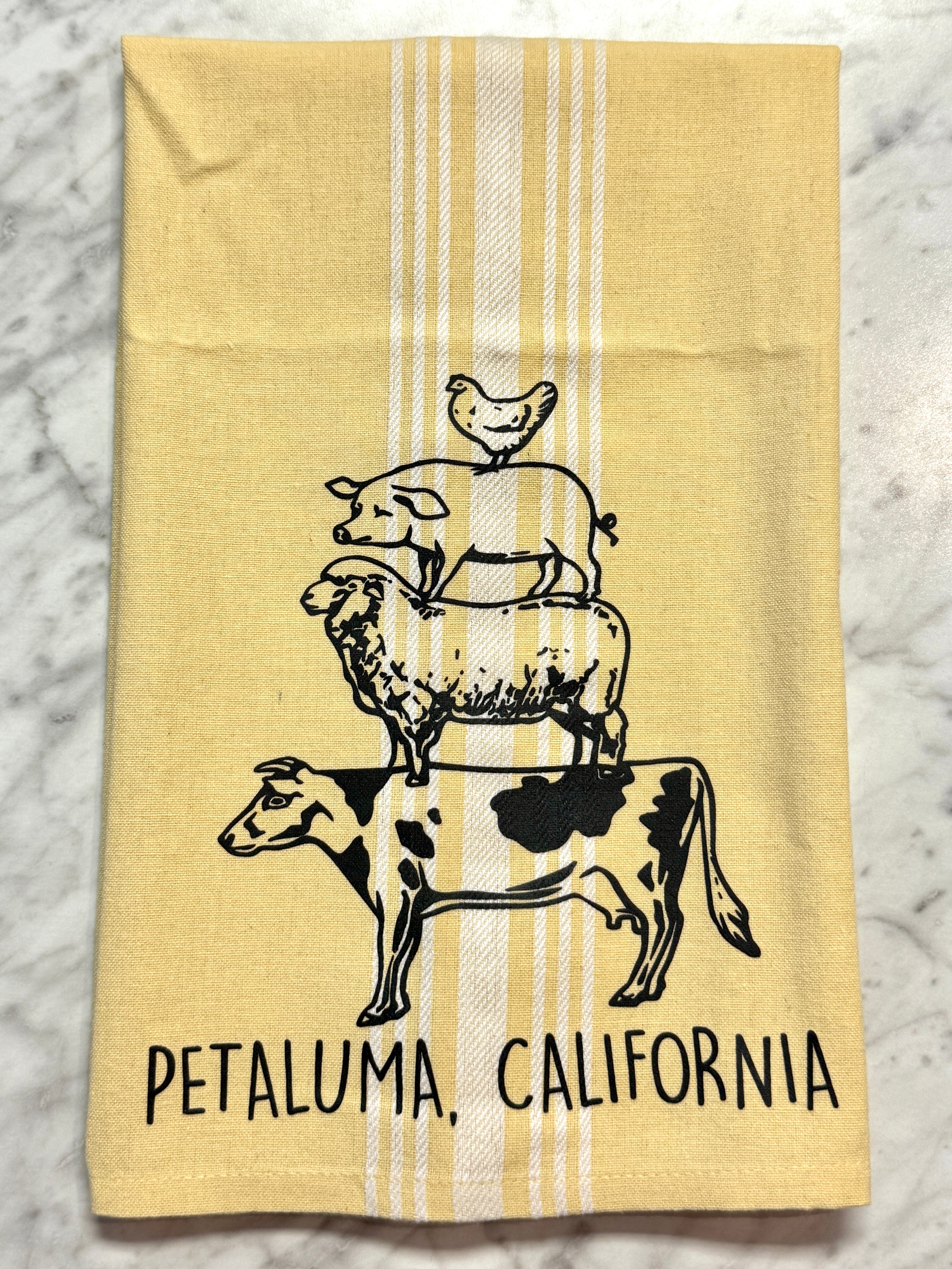 Yellow towel with black and white illustrations of animals and &