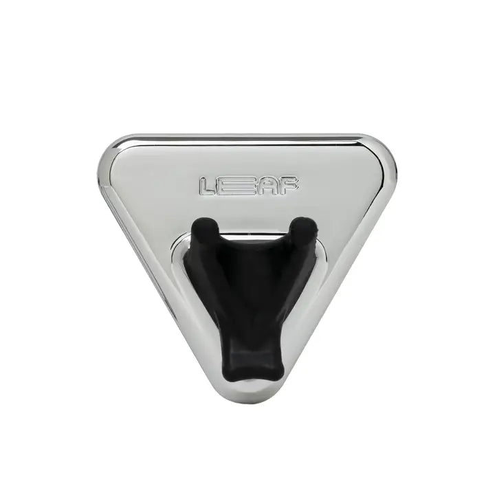 The Leaf Razor Accessories by Leaf is a triangular, chrome-colored metal wall hook inspired by safety razors, featuring "LEAF" engraved above two black, angled prongs in a V shape.