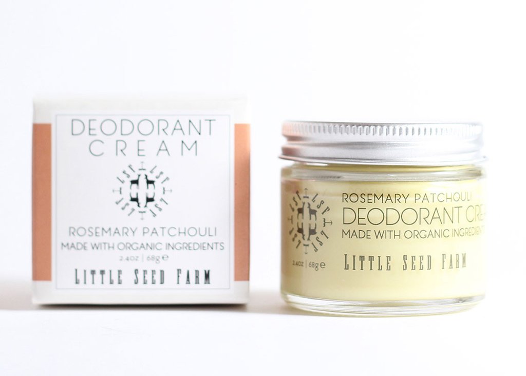 A partially open jar and box of Little Seed Farm Deodorant Cream from Little Seed Farm, shown in the Rosemary Patchouli scent. Labeled as organic, this aluminum-free deodorant is made with sustainable ingredients.