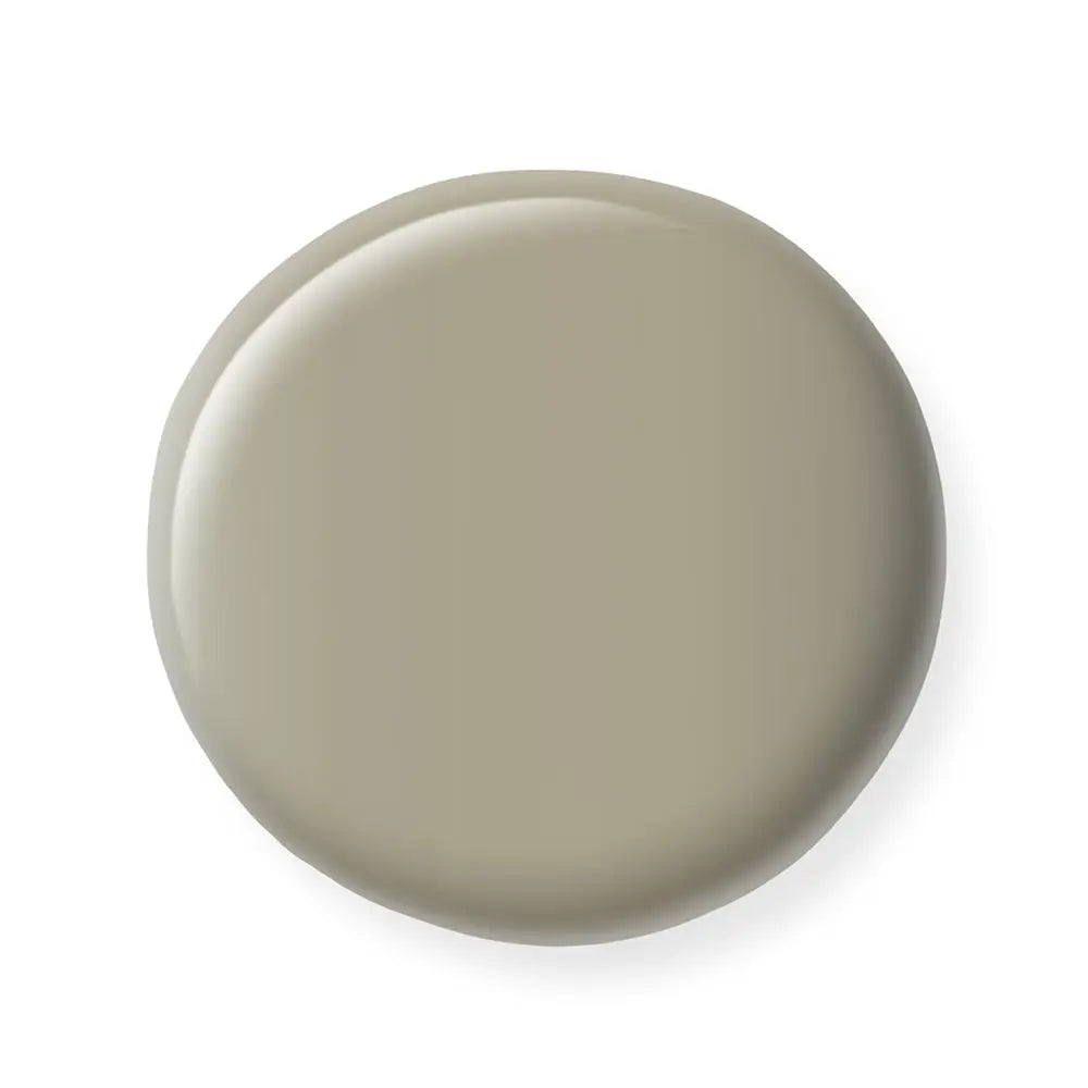 Round beige nail polish sample on a white background