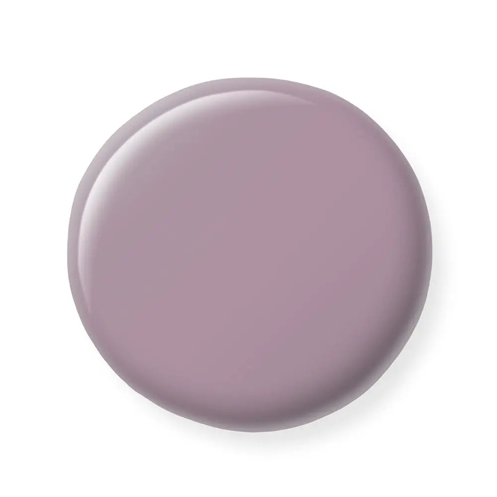 Round purple nail polish sample on a white background