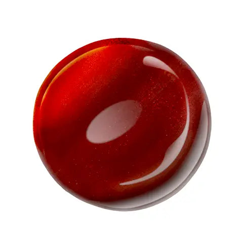 Red sparkle nail polish sample on a white background