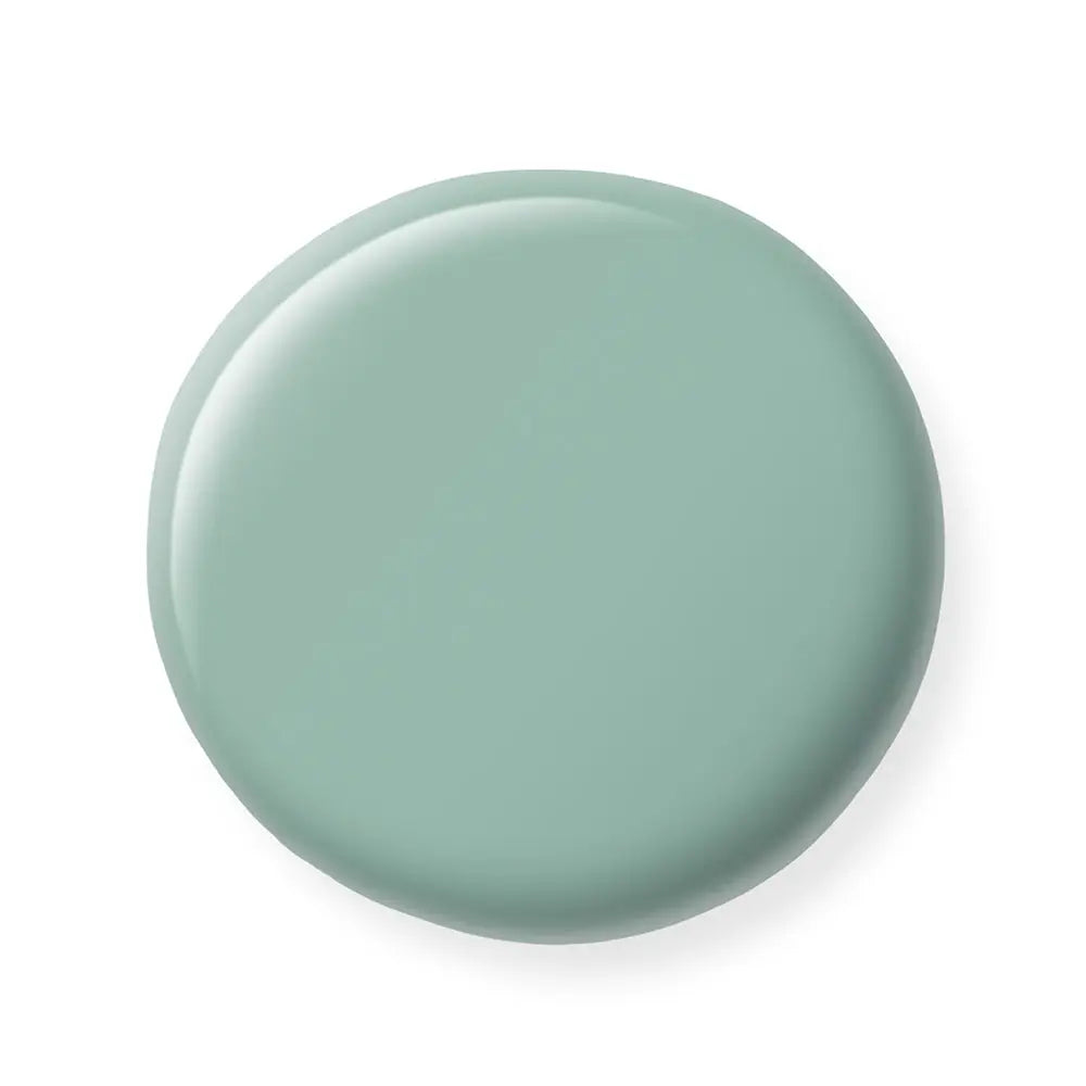 Round greenish nail polish sample on a white background