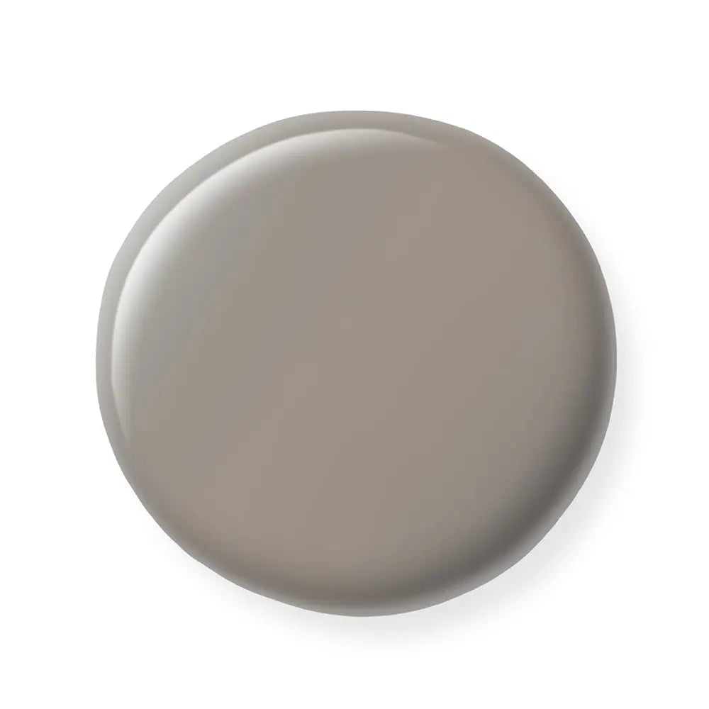 Round gray nail polish sample on a white background
