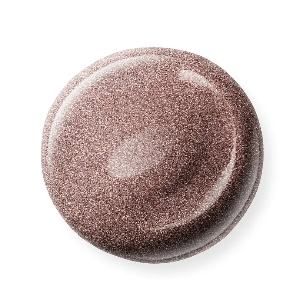 Round, brown nail polish sample on a white background