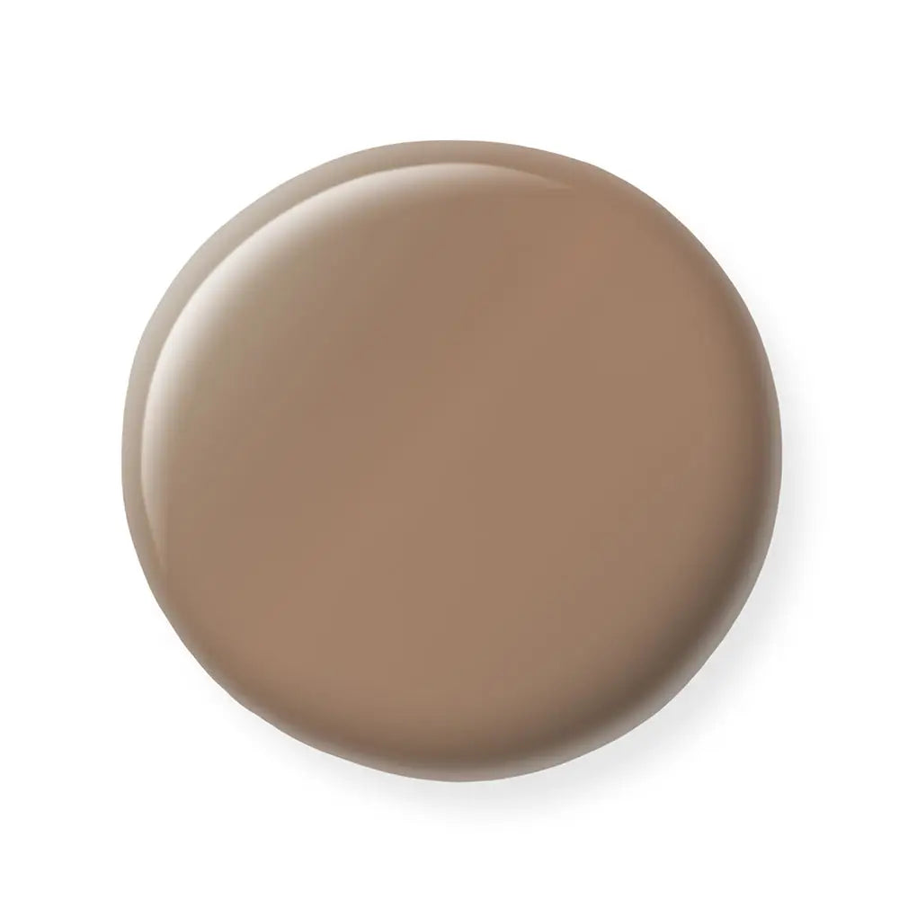 Brown circular nail polish sample on a white background