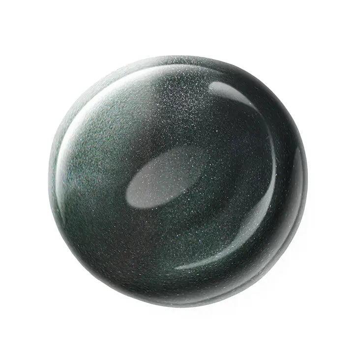 Round dark green nail polish sample on a white background