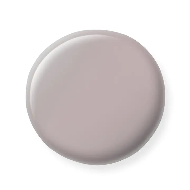Round gray nail polish sample on a white background