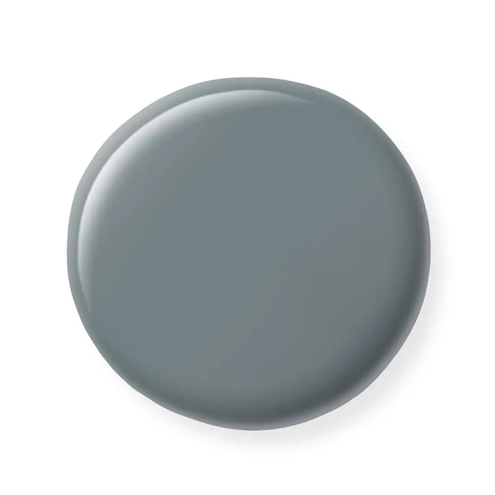 Round gray nail polish sample on a white background