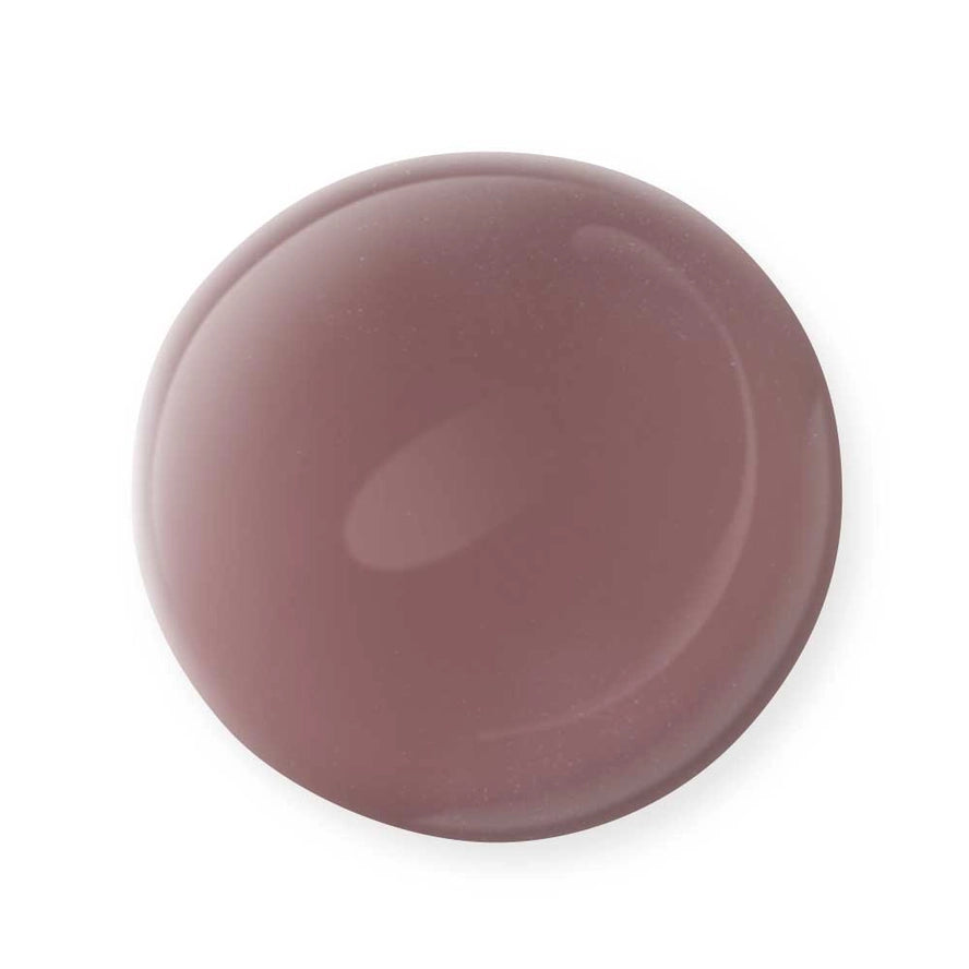 A glossy, round droplet of Mineral Fusion Nail Polish by Mineral Fusion in a rich mauve shade rests on a white background, highlighting the appeal of this non-toxic, clean beauty favorite.