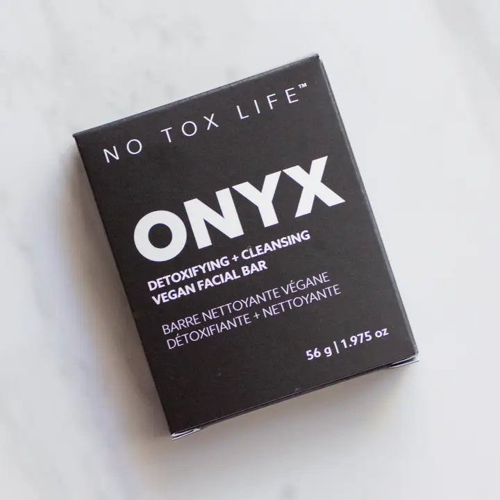 A black box of Solidsilk® Onyx - Facial Cleansing Bar by No Tox Life sits on a light surface. The vegan packaging features white English and French text, showing a weight of 56g (1.975 oz).