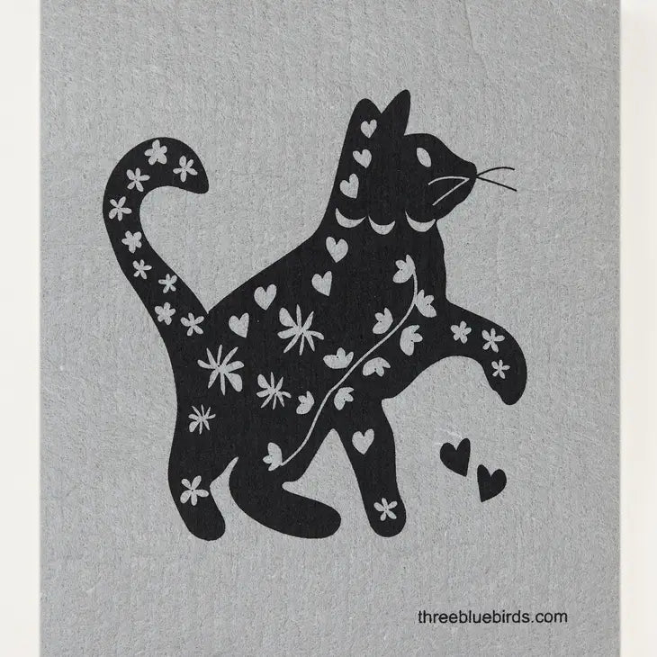 The Cats and Dogs Swedish Dishcloth by Three Bluebirds Swedish Dishcloths features a black cat silhouette with white hearts and flowers on a light gray background. Biodegradable & eco-friendly.