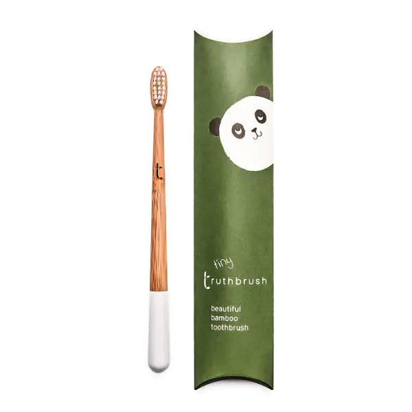 truthbrush toothbrush small bamboo with white tip next to green box with a panda on it