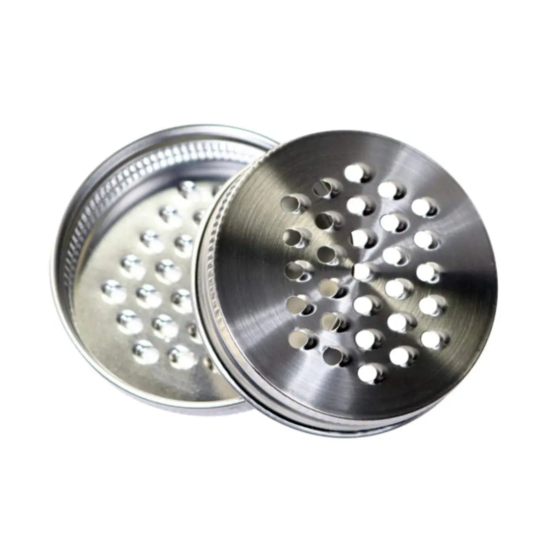 Two metallic grinder components on a white background