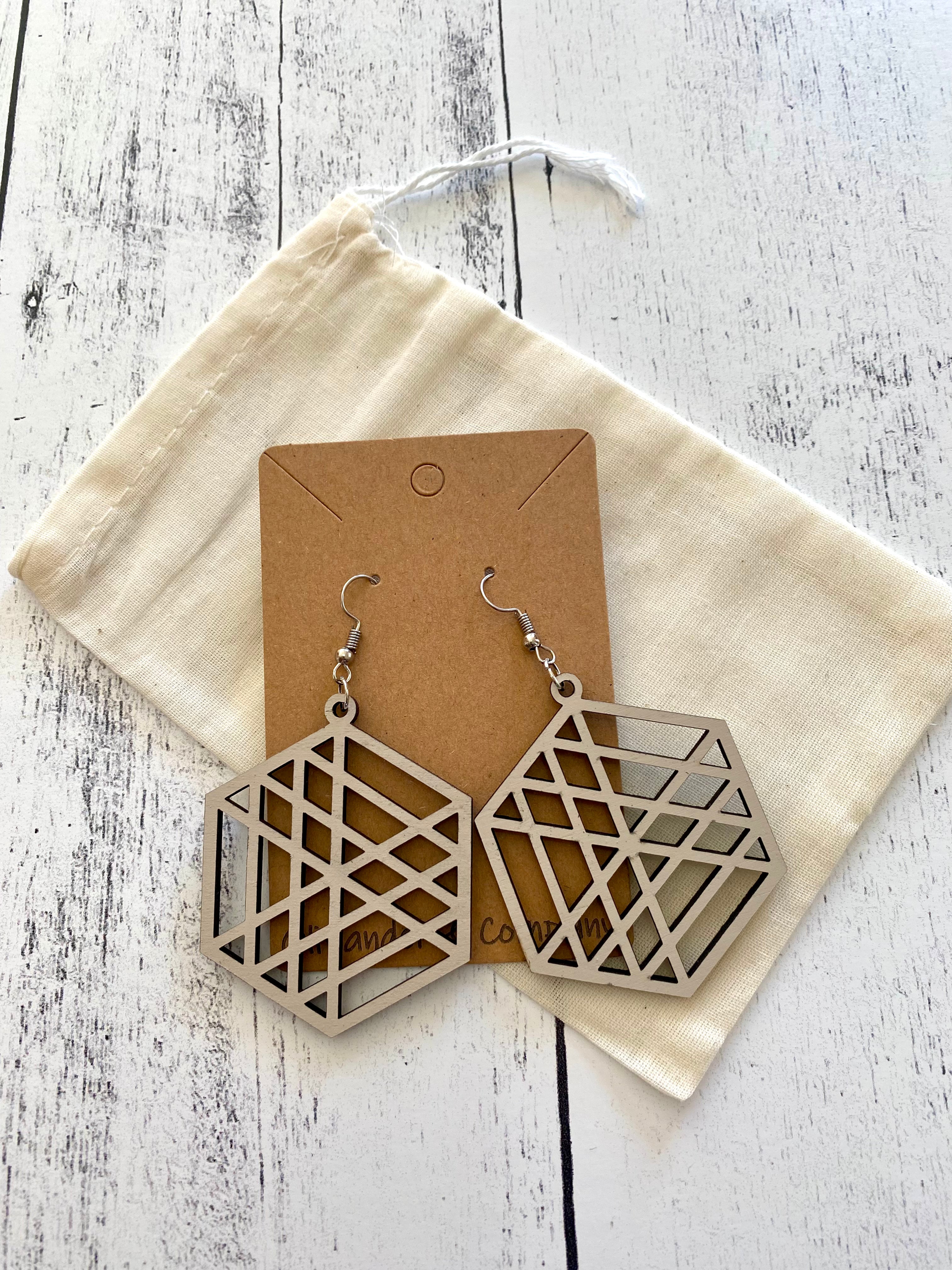 white wood laser earrings with muslin fabric pouch