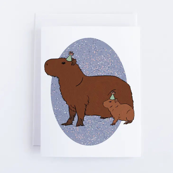 Illustration of two capybaras in party hats on a speckled purple background with an oval border. A charming design by Bean Horse Car Designs, perfect for eco-conscious Greeting Cards.
