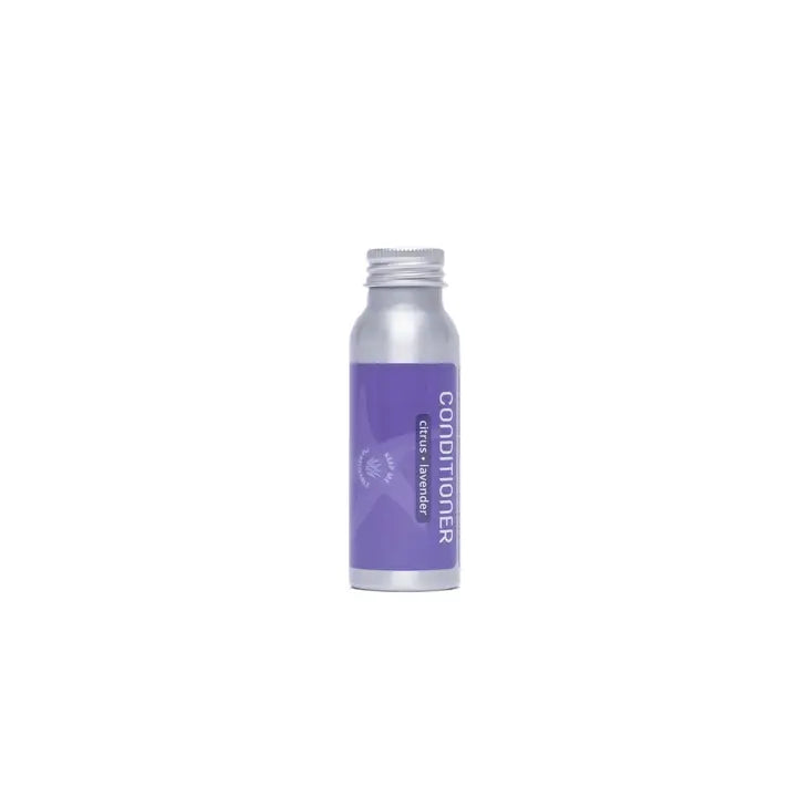 A small silver, refillable aluminum Plaine Products Conditioner bottle with a purple label that displays CONDITIONER in white text, standing upright against a plain white background.