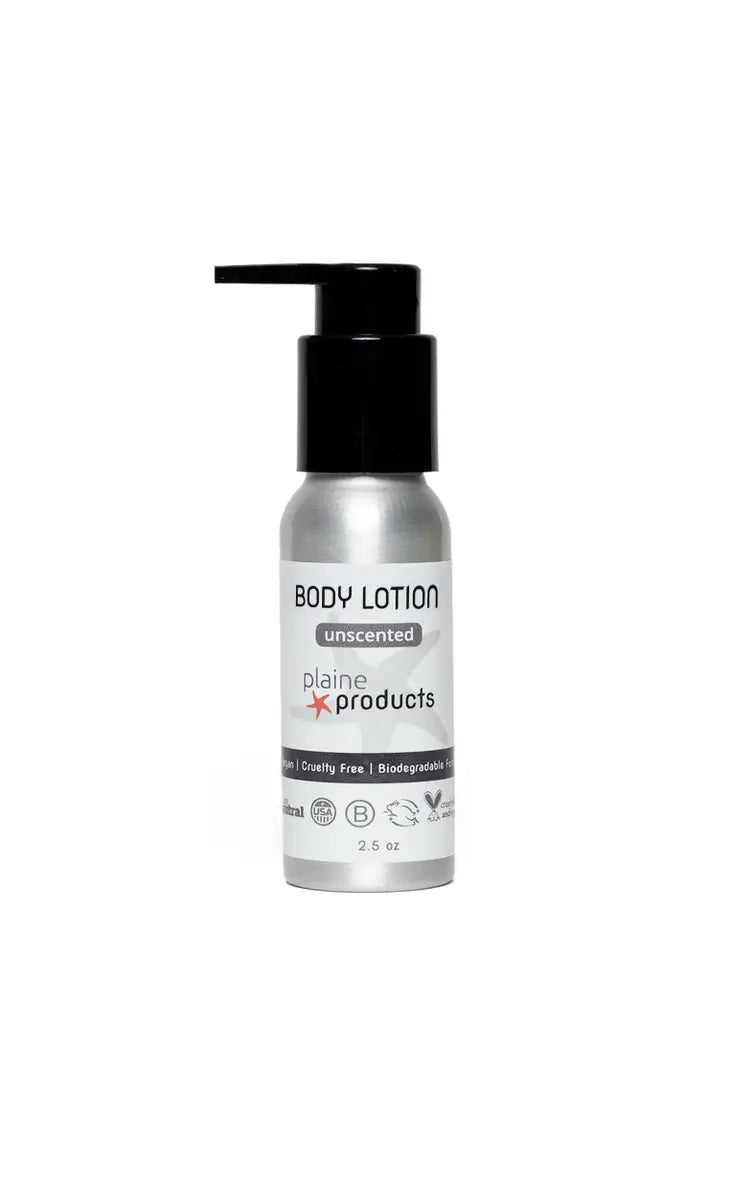 A 2.5 oz silver Plaine Products Lotion bottle with black pump, labeled “unscented,” “cruelty free,” and “biodegradable.” Plastic-free, refillable travel size by Plaine Products, featuring a minimalist design on a white background.