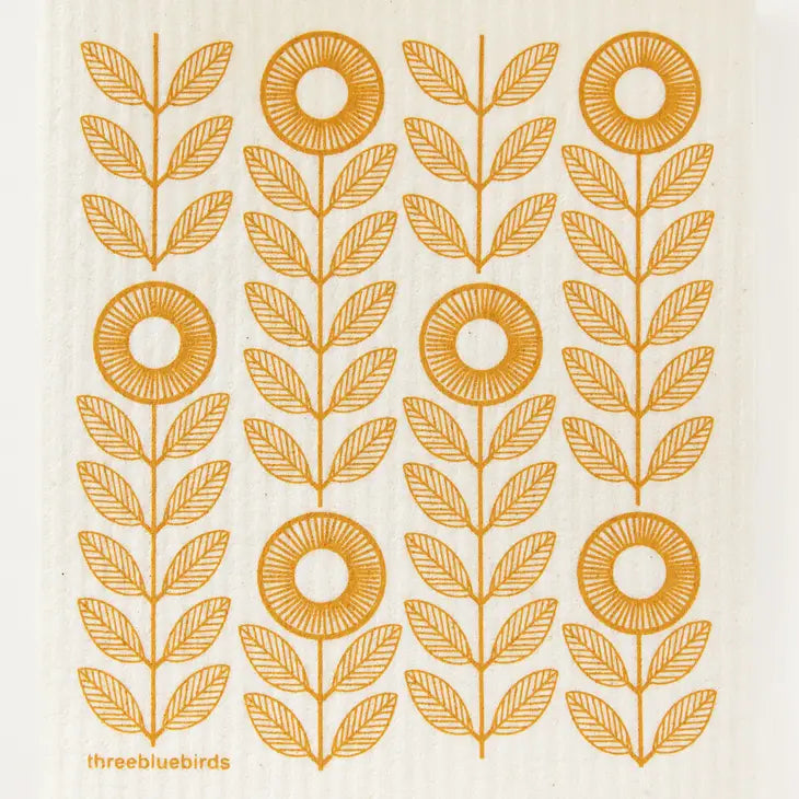 The Sunflowers Swedish Dishcloth by Three Bluebirds Swedish Dishcloths features stylized orange sunflowers with round centers and pairs of leaves in vertical rows on a cream background—adding charm to any eco-friendly, biodegradable cleaning cloth.