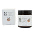 A jar of 8 Days Botanicals Body Butter - Rose Sandalwood sits beside its box, both with white labels featuring black, gold, and pink text, a rose illustration, and details about nourishing organic butters.