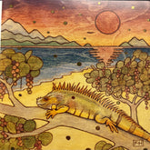 A vibrant illustration on Fay Helfer Greeting Cards by artist Fay Helfer features an iguana on a tree branch, berries, a beach, mountains, and a red sun setting over the ocean.