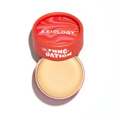 An open Axiology Fungdation Mushroom Foundation shows its light beige, hydrating cream in a round container with a red, wavy-patterned lid, elegantly displayed on a white background.