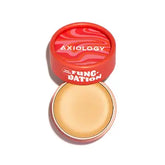 A round, open red container holds hydrating Fungdation Mushroom Foundation. The angled lid features the Axiology brand name and "Fungdation" in bold white on a red and pink swirled background.