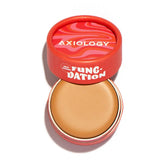 An open Axiology Fungdation Mushroom Foundation in a red and pink swirled container with the lid behind, showing the tan, hydrating makeup inside.