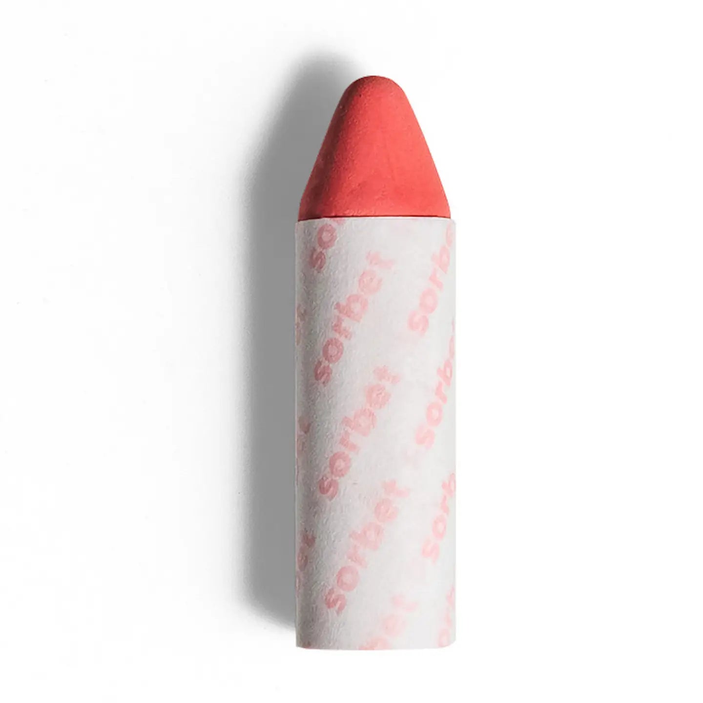 The Axiology 3-in-1 Balmie Crayon Singles in coral pink features a rounded tip and white paper wrap with "sorbet" in light pink—ideal for plastic-free makeup routines, shown isolated on a white background. 