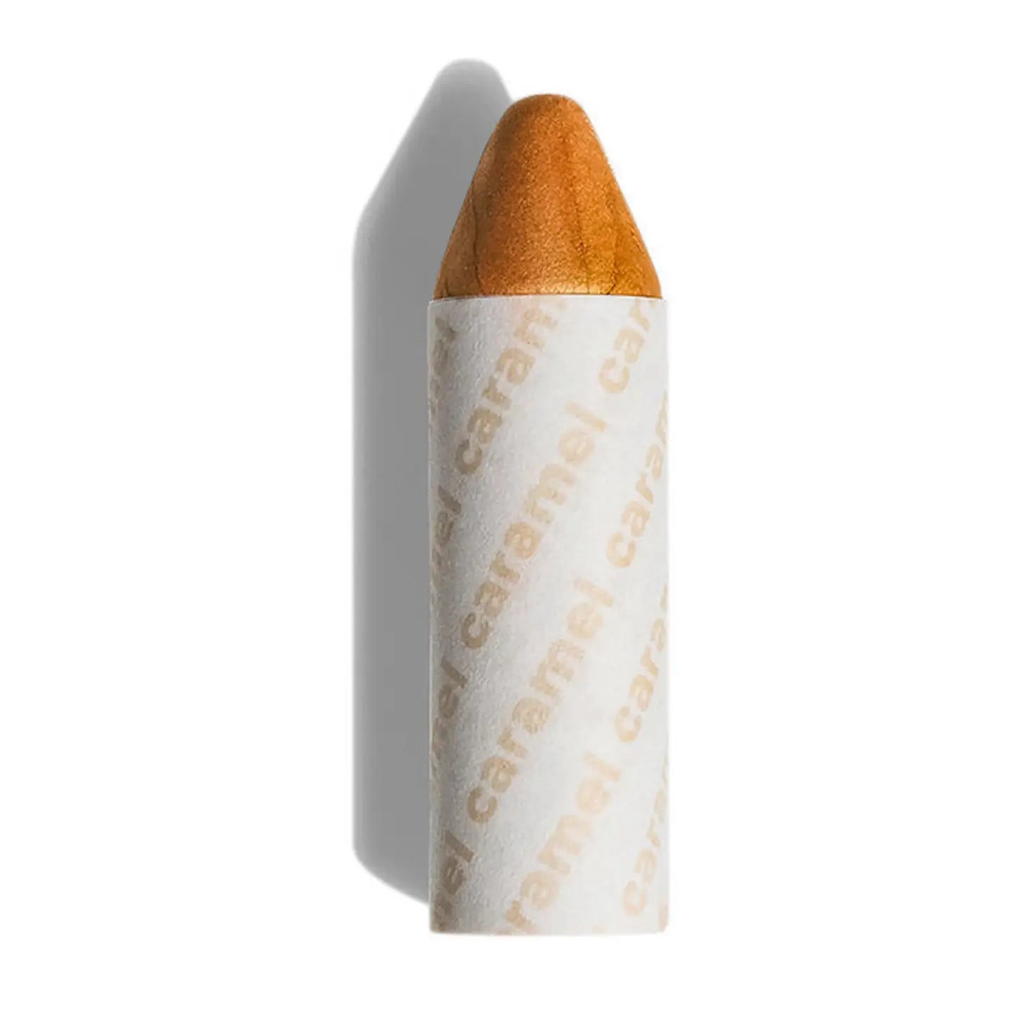 Axiology’s 3-in-1 Balmie Crayon Single in a short, orange stick partially wrapped in white paper printed with ”cinnamon” in brown—a perfect plastic-free choice for eco-conscious makeup lovers. 