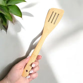 bamboo spatula held by a hand