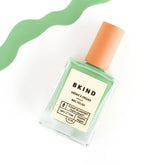 bkind nail polish in light green with a squiggle at the top